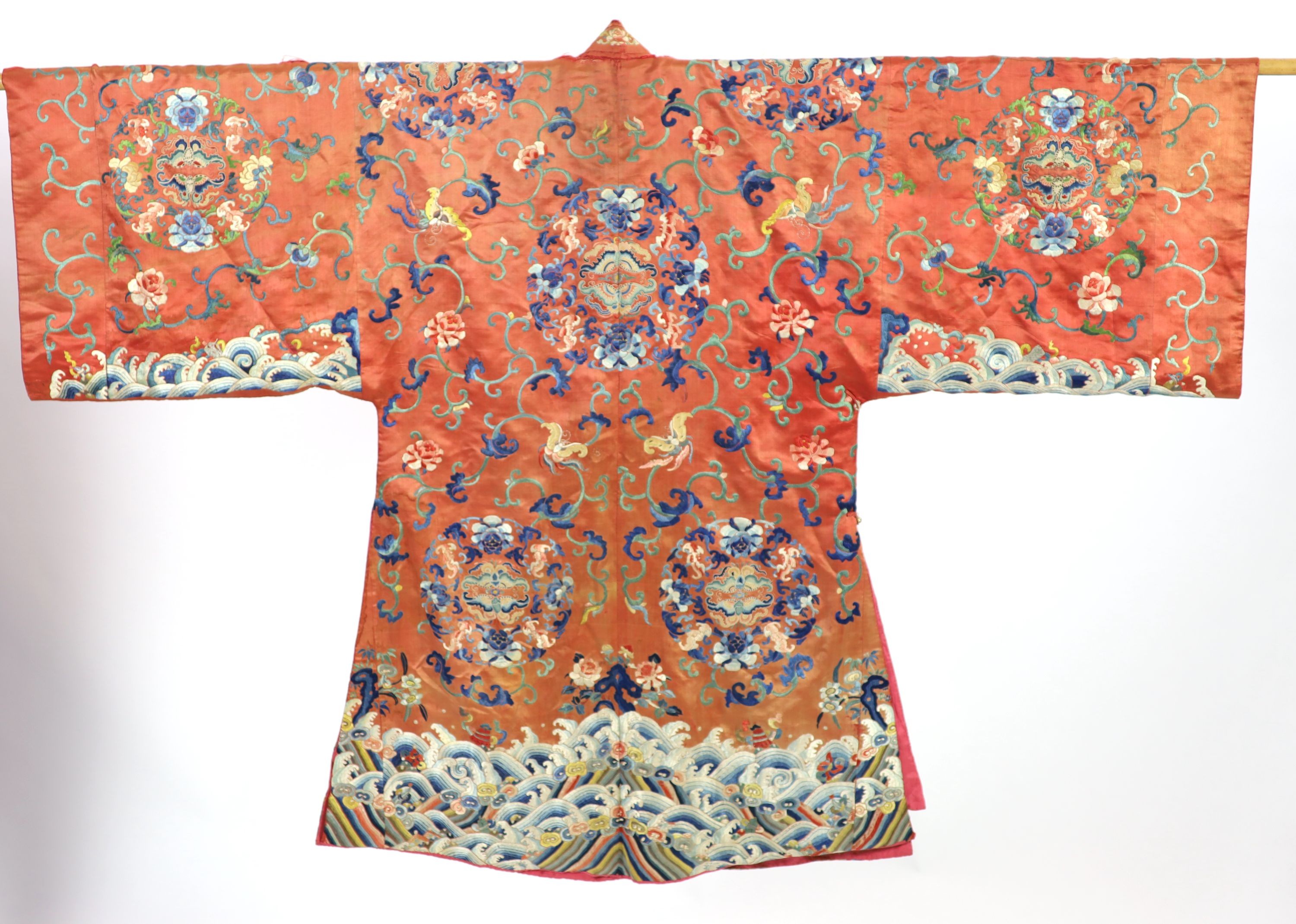A Chinese apricot silk robe, mid 19th century, 125 cm long, wear to back of collar